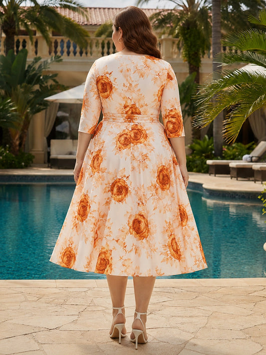 Orange floral plus size midi dress back view, round neck, center back zipper, 3/4 sleeves and full pleated A-line skirt