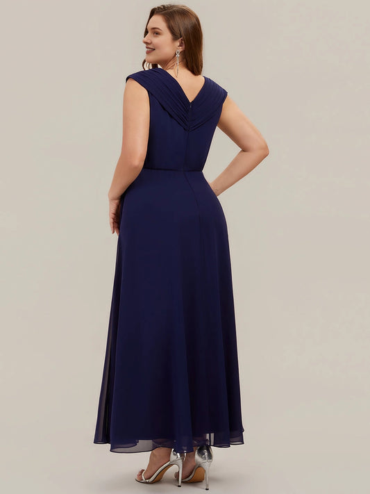 Navy plus size chiffon gown back view, V-back, draped cap sleeves, center back zipper and flowing A-line long skirt