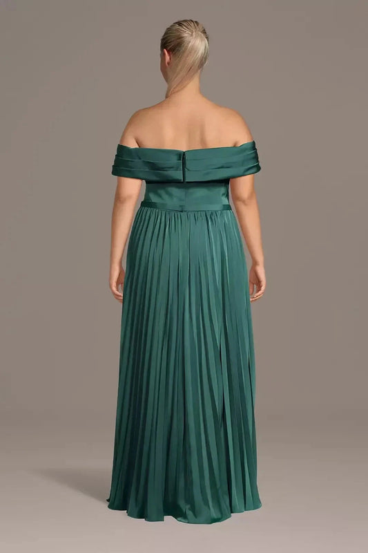 Emerald green plus size wedding guest dress featuring off-shoulder sleeves, straight zipper back, defined waist and flowing pleated floor-length skirt