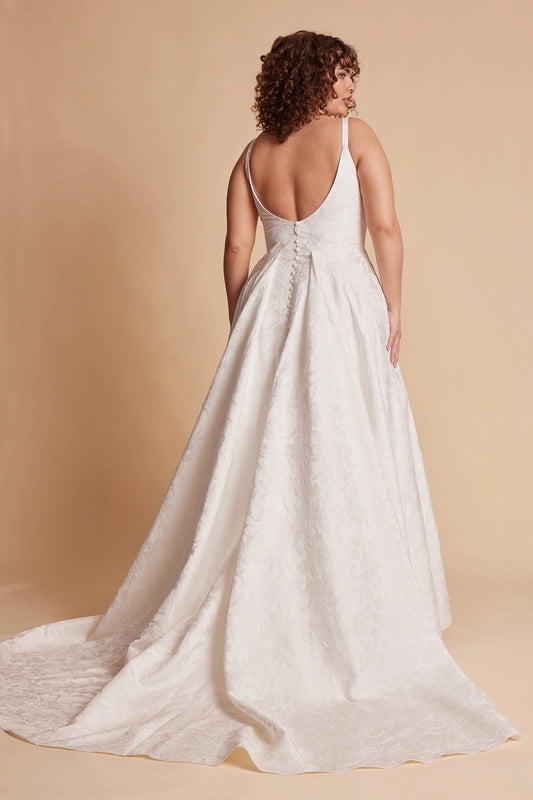 Ivory plus size floral wedding dress with low scoop back, covered button details, fitted waist and flowing A-line skirt with train