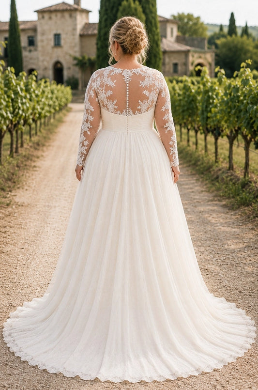 Ivory plus size wedding dress with sheer floral lace back, pearl-style button details, long sleeves and flowing tulle train