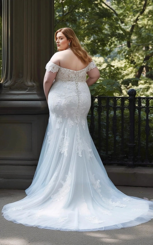 Ivory plus size mermaid wedding dress with floral lace appliques, button-style back detailing and flowing tulle train