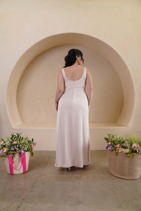 Back view of champagne plus size bridesmaid dress featuring a scoop back, zipper closure and floor-length sheath skirt by roselledress