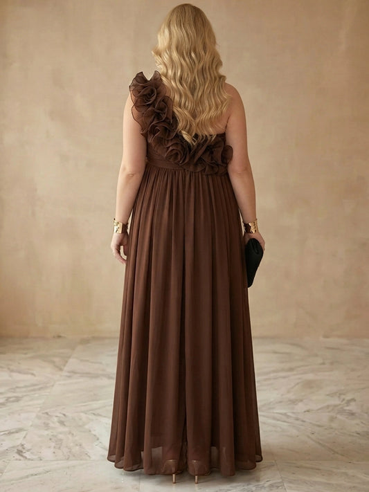 Brown plus size evening gown back view, one shoulder with ruffle flower detail, empire waist and flowing pleated chiffon maxi skirt

