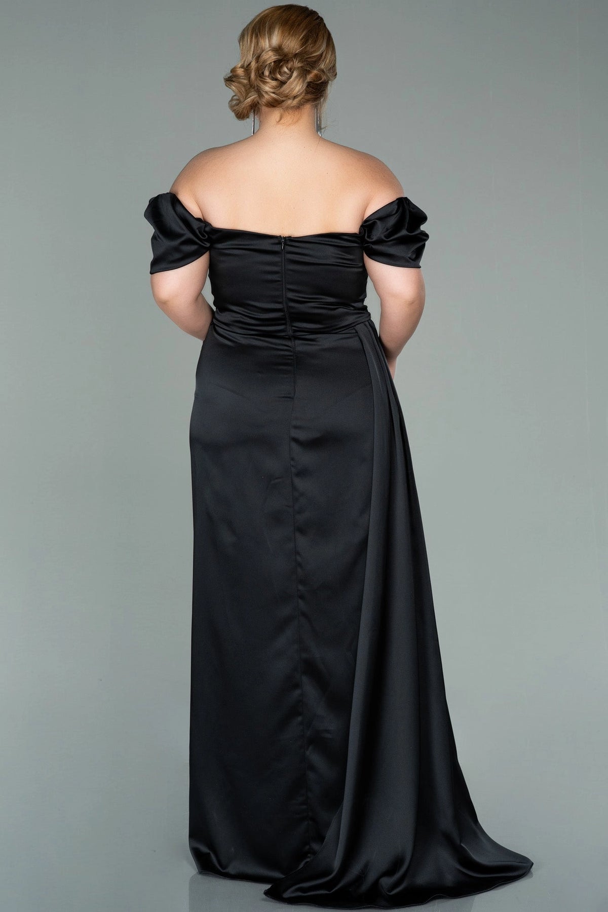 Back view of a roselledress plus size black satin off shoulder evening dress with zipper back and drape
