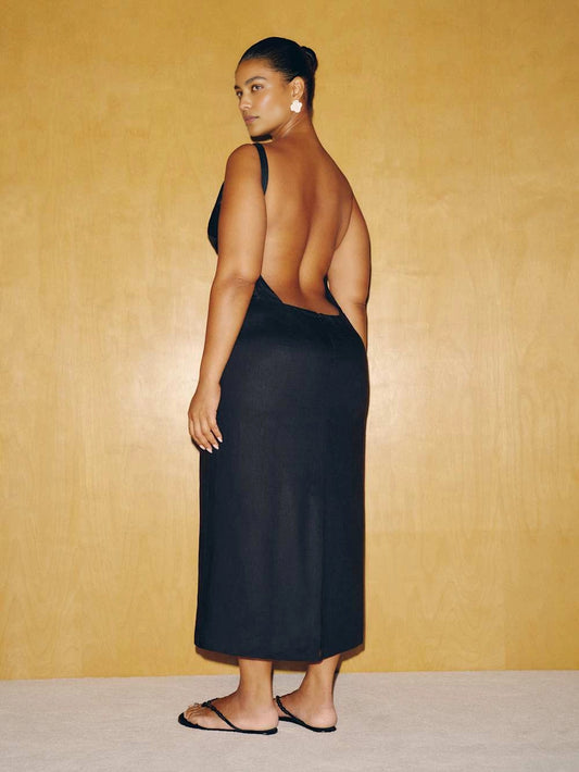 roselledress black plus‑size midi formal dress dramatic deep open back single thin strap column silhouette modern wedding guest dress back view