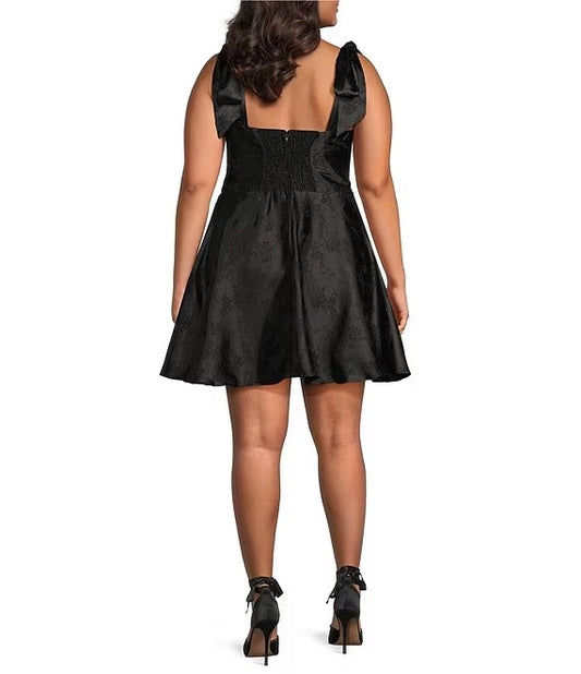 Plus size black homecoming dress featuring smocked back and bow tie shoulder straps