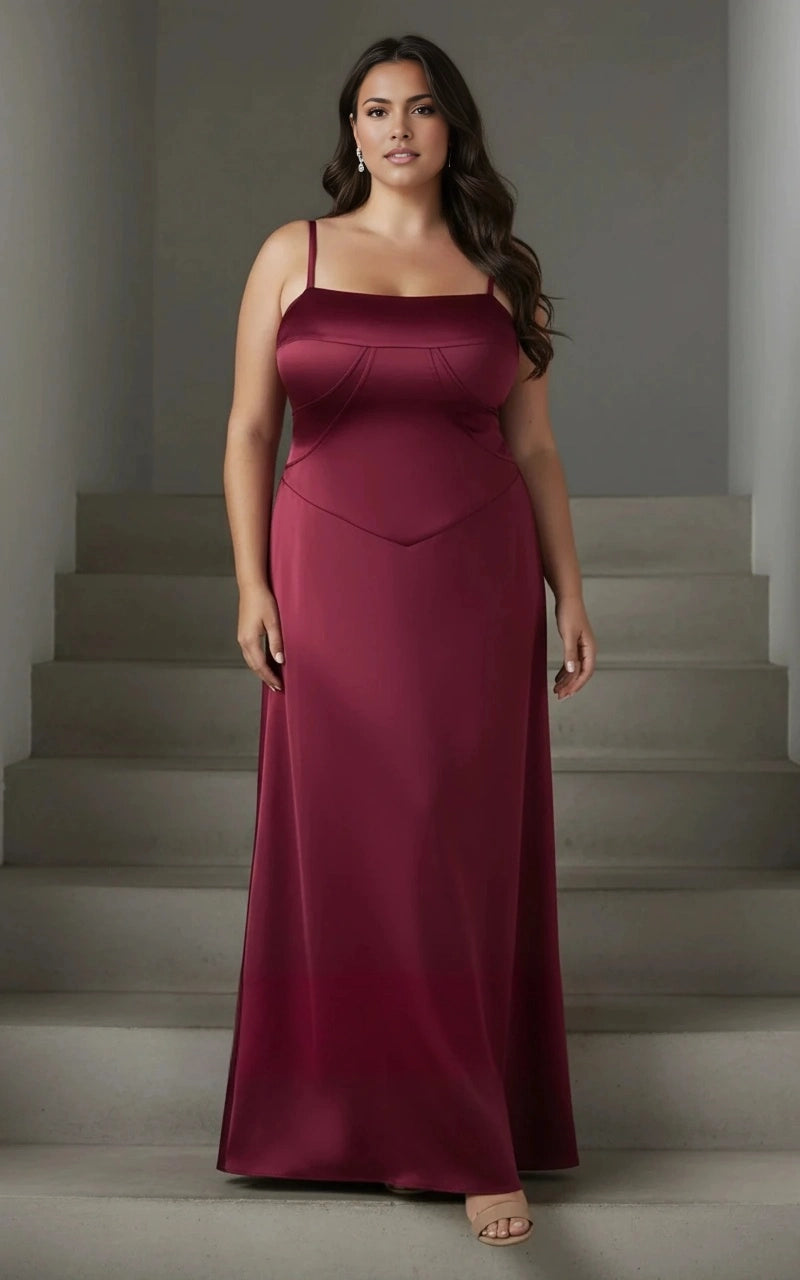 Burgundy plus size wedding guest dress with square neckline, spaghetti straps, structured bust seams, basque waist and floor-length satin-look skirt
