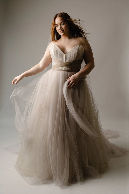 Champagne plus size A-line wedding dress with sweetheart neckline, off-shoulder tulle straps, crisscross waist and layered floor-length skirt