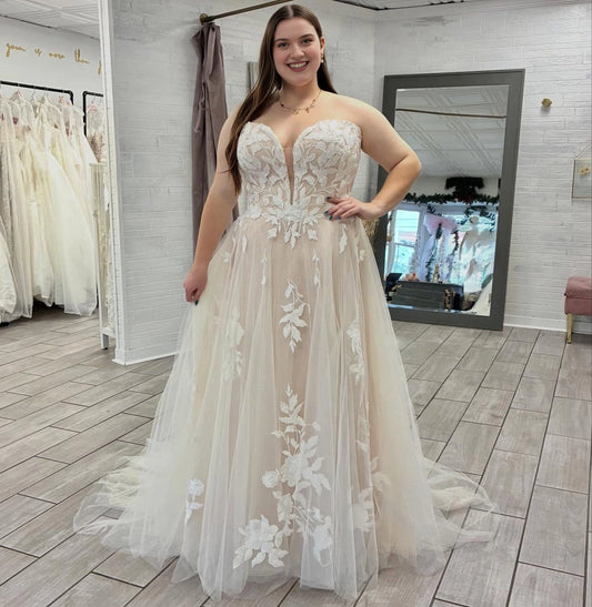 Ivory plus size A-line wedding dress with plunging V-neck, strapless floral lace corset bodice and flowing tulle skirt
