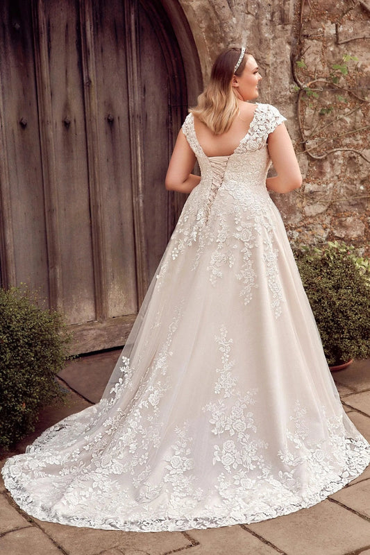 Ivory plus size wedding dress with V-shaped lace-up corset back, floral lace appliques and flowing lace-trimmed train