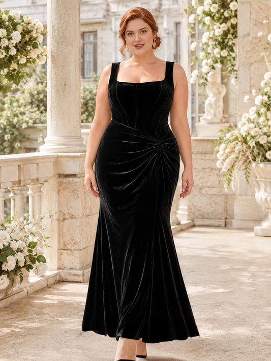 Plus size black velvet square neck corset wedding guest dress with wide straps, ruched twisted waist and mermaid floor length skirt, front view
