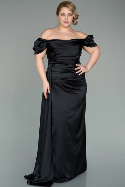 Front view of a roselledress plus size black satin off shoulder long evening dress with side drape