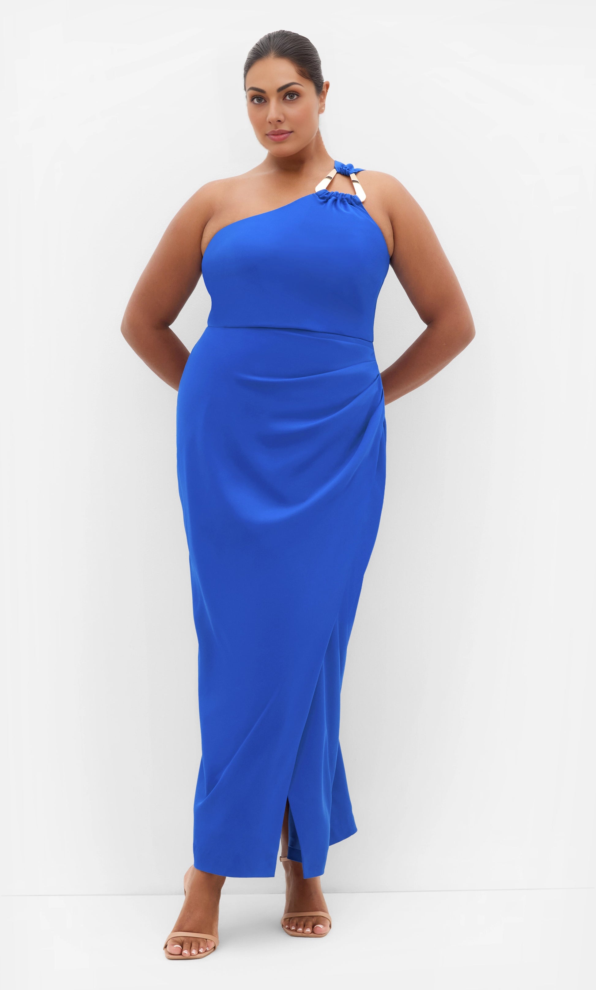 RoselleDress cobalt blue plus size maxi wedding guest dress one‑shoulder metallic hardware detail draped wrap skirt front slit floor‑length front view