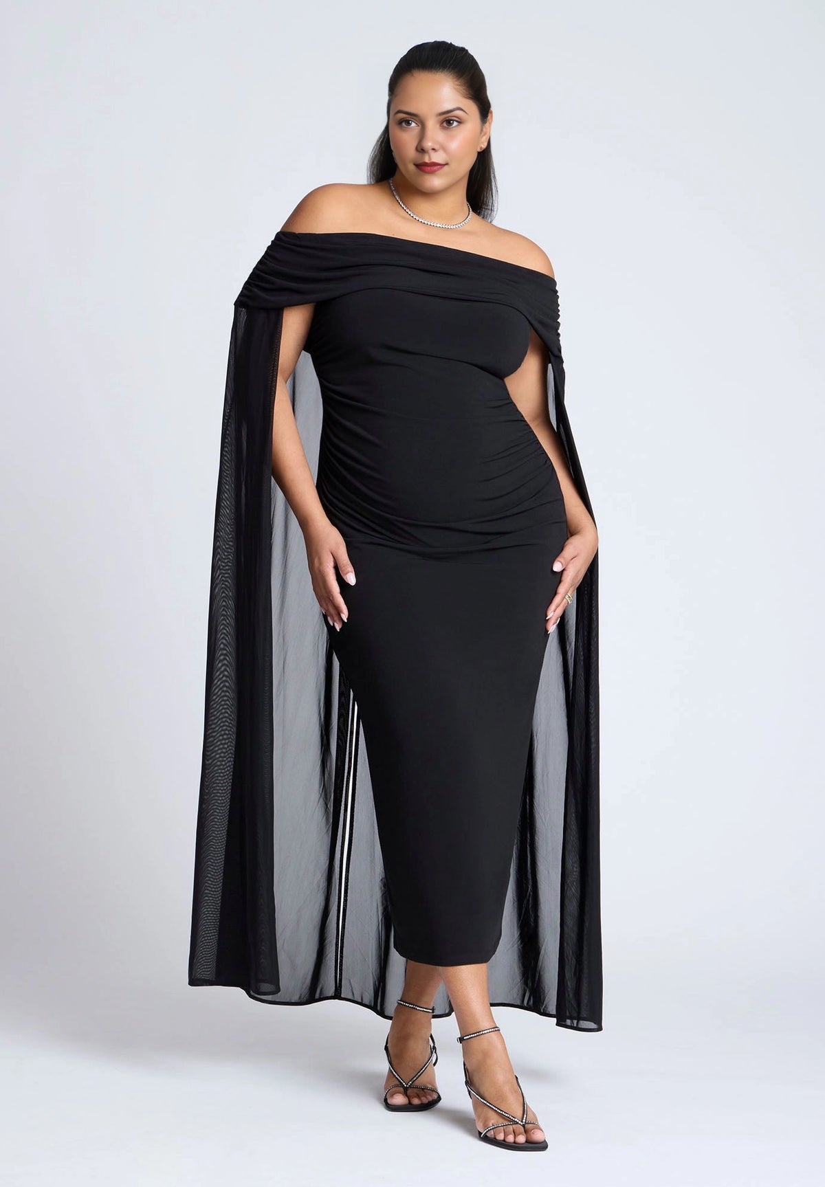 Roselle Dress plus size black off‑the‑shoulder ruched midi wedding guest dress with flowing mesh cape sleeves front view
