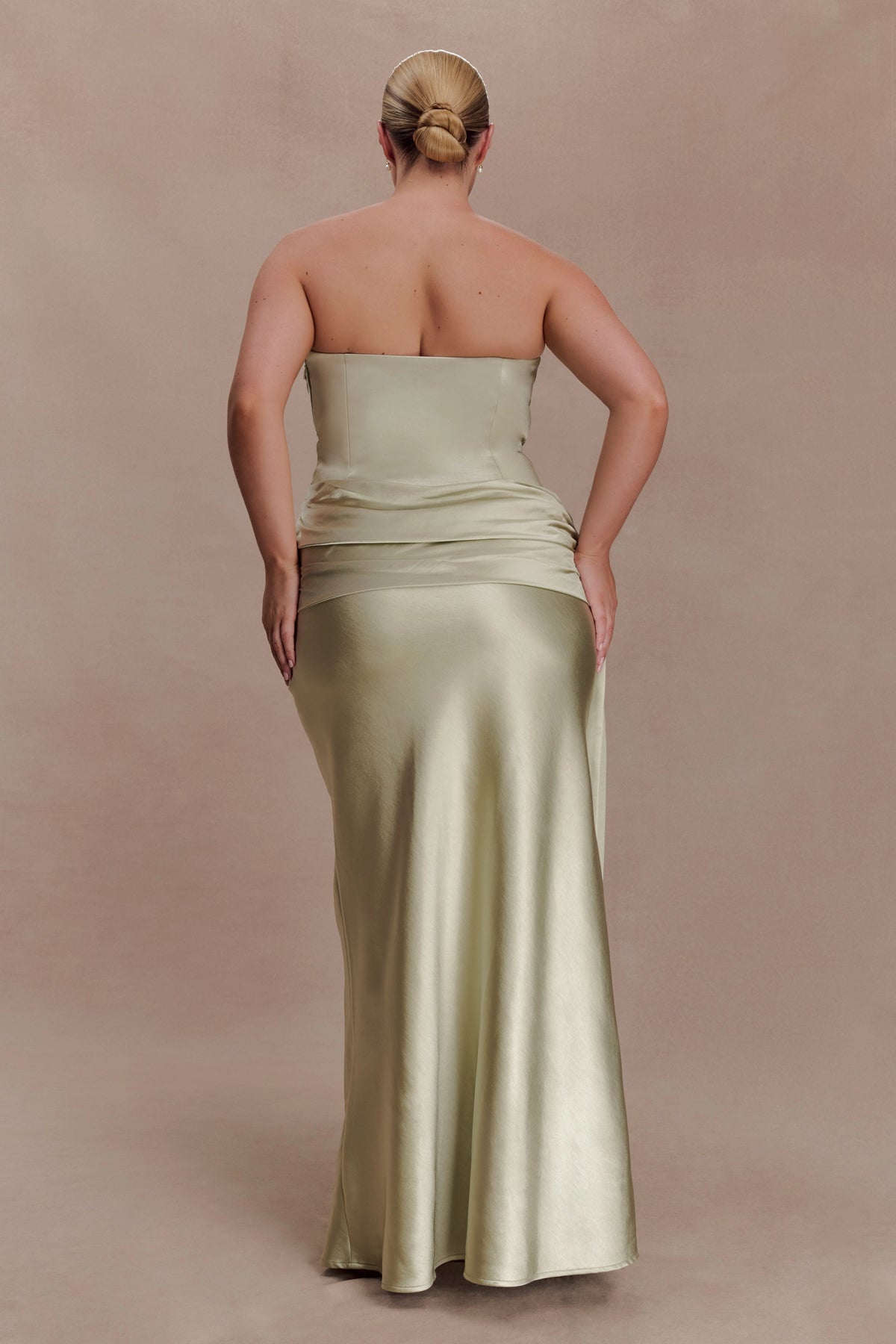 Sage green plus size strapless evening dress with straight back neckline, ruched waist, fitted hips and floor-length mermaid skirt back view